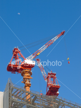 Construction cranes in Umeda on Shutterstock.com